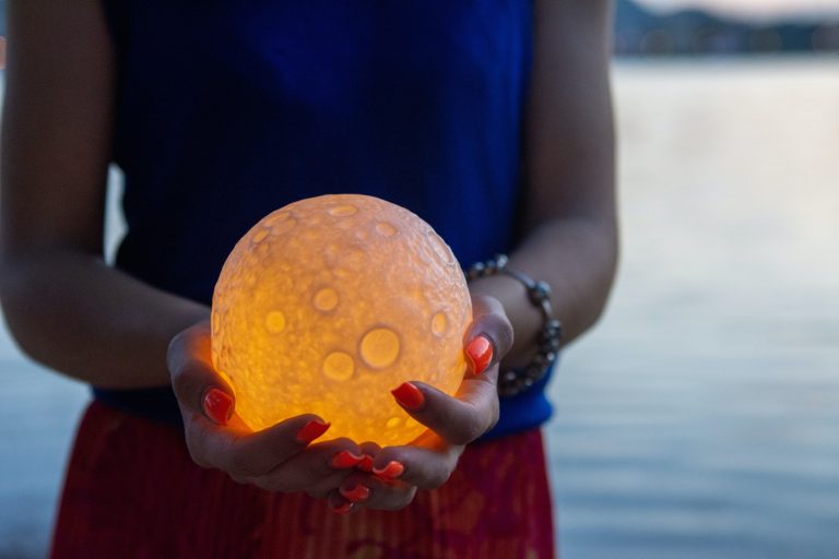 Close up moon in woman's hands. Astrology concept
